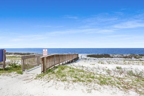 a boardwalk to the beach with the ocean in the background at Beach View Lower by Pristine Properties Vacation Rentals in Mexico Beach