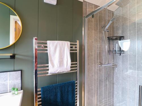 a bathroom with a shower and a towel on a rack at Oak in Swadlincote