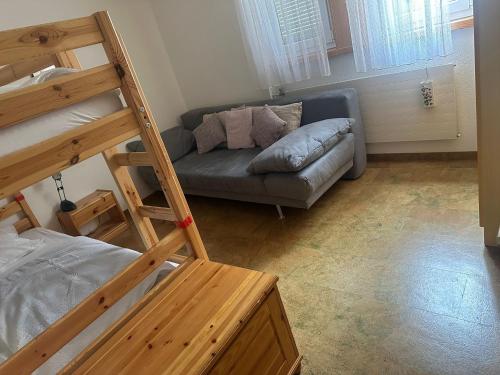 a living room with a couch and a bunk bed at Appartement avec grande terrasse Loèche les Bains in Leukerbad