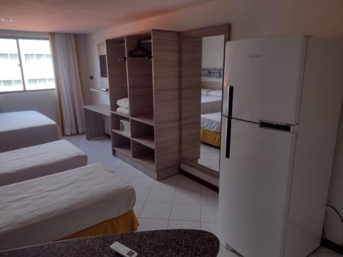 Postel nebo postele na pokoji v ubytování Ambassador Unidades Autônomas