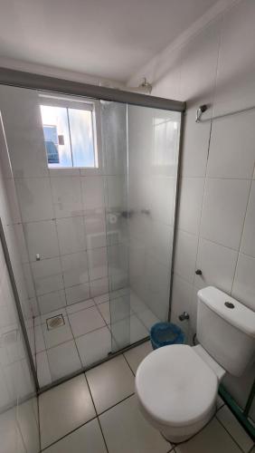 a white bathroom with a toilet and a shower at Lacqua diRoma 1 - Apartamentos JN in Caldas Novas