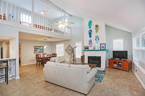 a living room with a couch and a fireplace at Sharkey's by Pristine Properties Vacation Rentals in Cape San Blas