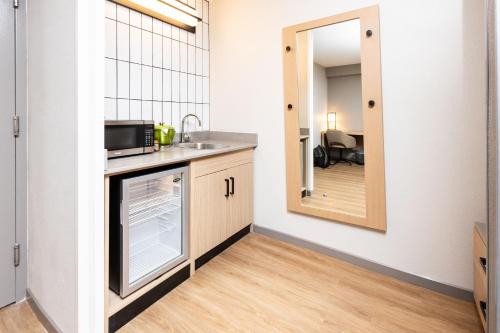 a kitchen with a sink and a dishwasher at Hyatt Place Greenville/Haywood in Greenville