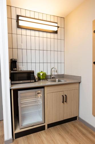a kitchen with a sink and a microwave at Hyatt Place Greenville/Haywood in Greenville