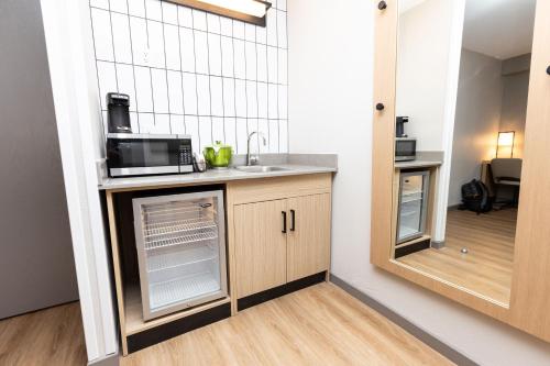 a kitchen with a sink and a microwave at Hyatt Place Greenville/Haywood in Greenville