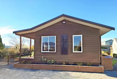 a small house with two windows at Blue Ridge Studios and Bed & Breakfast in Te Anau