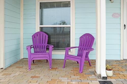 two purple chairs sitting on the front porch of a house at Sunset Blvd by Pristine Properties Vacation Rentals in Saint Joe Beach