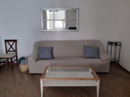 sala de estar con sofá y mesa de centro en Casa dúplex en el centro en Carmona