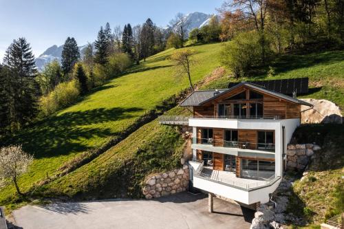 a house on the side of a hill at DasKöniglich Luxury Alpine Chalet - Mühlbach am Hochkönig in Mühlbach am Hochkönig