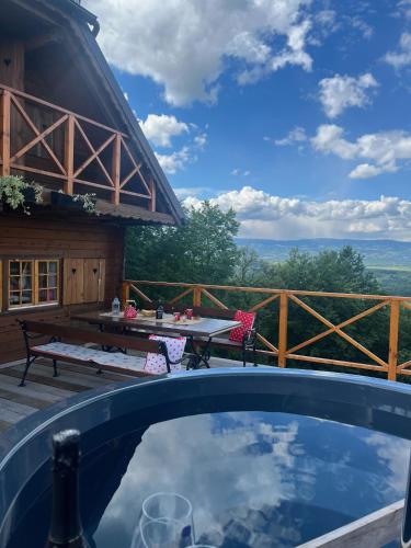 a swimming pool with a table and a picnic table at Brunarica Dežno in Makole
