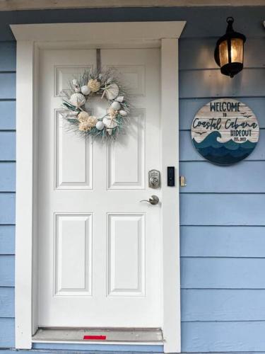 a door to a blue house with a wreath on it at 10 min Lido Key Beach ~Coastal Cabana Hideout in Sarasota