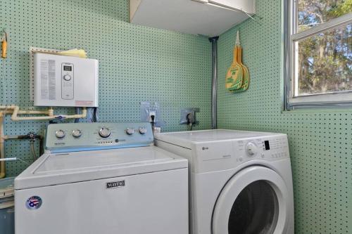 a laundry room with a washing machine and a window at 10 min Lido Key Beach ~Coastal Cabana Hideout in Sarasota