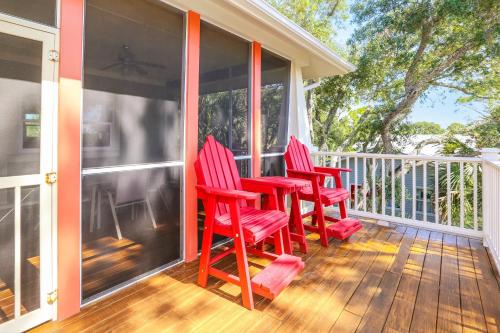 three red chairs sitting on a porch at Attitude Adjustment by Pristine Properties Vacation Rentals in Indian Pass