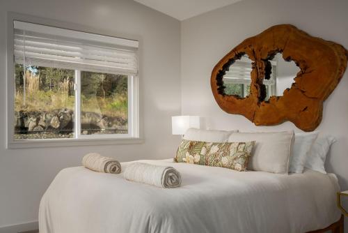 a bedroom with a bed with a mirror on the wall at 5-Star Luxury Sauna-Spa Retreat Near Volcano Nat'l in Volcano