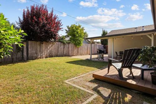 a chair sitting on a deck in a yard at Trinity Escape Entire home near Lodi Lake in Lodi