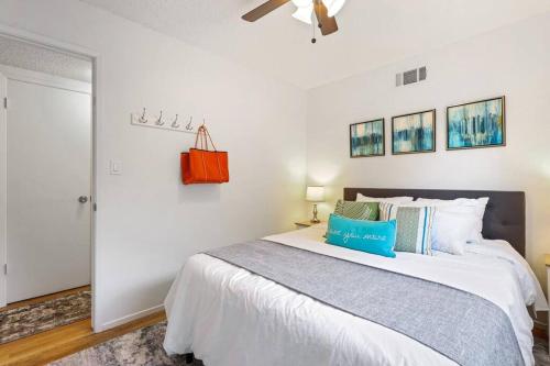 a bedroom with a large white bed and a ceiling fan at Trinity Escape Entire home near Lodi Lake in Lodi