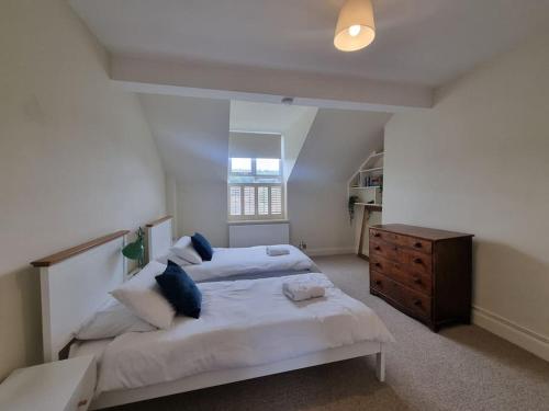 a bedroom with a large bed and a wooden dresser at Contemporary apartment in Cromer in Cromer