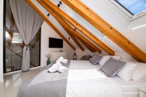a bedroom with two beds in a attic at Apartment Nezi in Pučišća