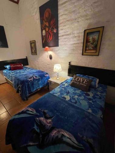 a bedroom with two beds and a love pillow at Casa Villas Suizas I cerca de Laberinto de Albania in Apaneca