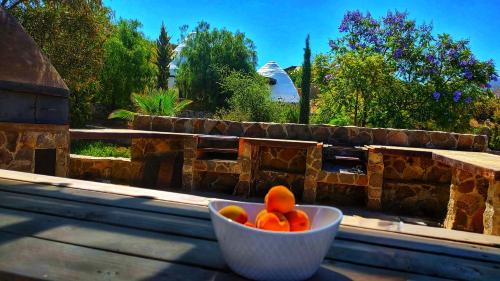 a bowl of fruit sitting on a window sill at Hacienda Eco-Domes in Valle de Guadalupe