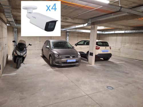 two cars and a motorcycle parked in a parking garage at Lux apartment 8, center, free parking in Niš