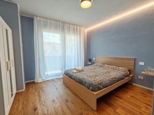 a bedroom with a bed with a teddy bear on it at Casa Maribella Cattolica in Cattolica