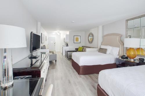 a hotel room with two beds and a flat screen tv at Elkotel in Elko