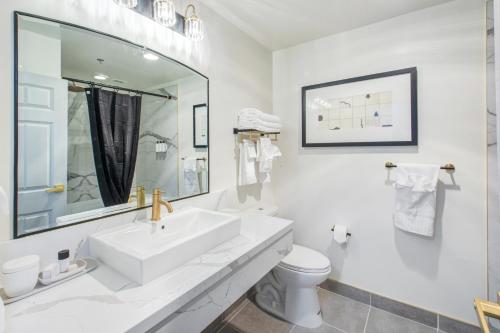 a white bathroom with a sink and a toilet at Elkotel in Elko