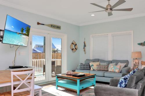 a living room with a couch and a tv at Casa Linda by Pristine Properties Vacation Rentals in Mexico Beach
