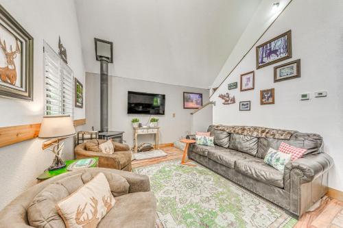 a living room with two couches and a tv at Quaint Cloudcroft Cabin with Stunning Forest Views! in Cloudcroft