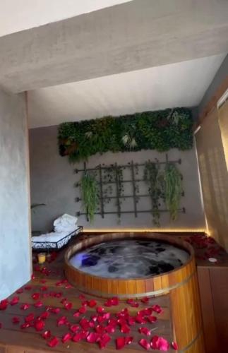 a room with a large tub filled with red flowers at Iron and Stones in Rio de Janeiro