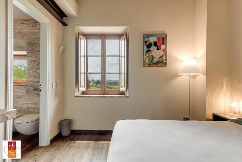 a bedroom with a white bed and a window at Chianti B&B Design infinity pool shared in Pianella