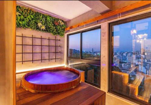 a bathroom with a tub in a room with a window at Iron and Stones in Rio de Janeiro