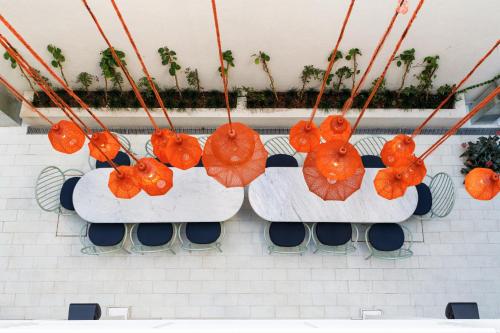 a group of orange decorations hanging from a wall at Bromelia Hotel Boutique in Buenos Aires