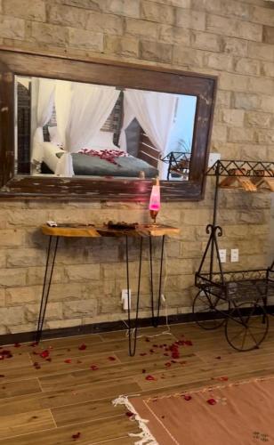 a bedroom with a bed and a large mirror at Iron and Stones in Rio de Janeiro
