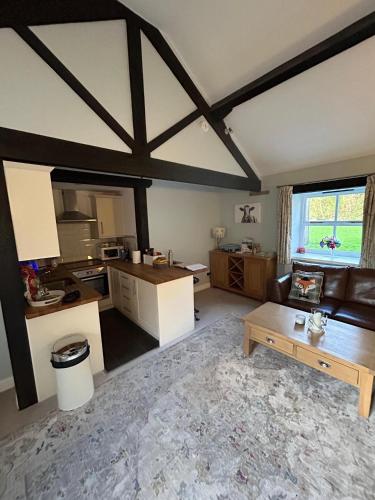 a living room with a couch and a table at Swallow Cottage in Ripon