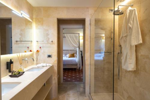 a bathroom with a shower and a sink and a tub at Borgo San Luigi in Monteriggioni