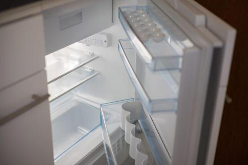 an empty refrigerator with its door open with its at Downtown Deluxe Studio with Queen Bed BE-26 in Zürich