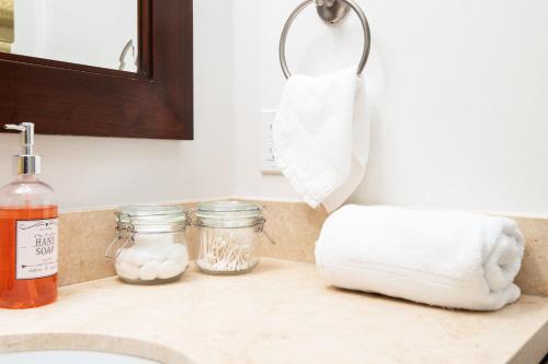 a bathroom counter with towels and a sink at Sky-Rise Apartments in Los Angeles