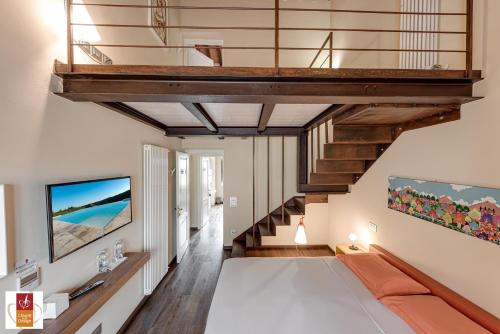 a living room with a staircase and a couch at Chianti B&B Design infinity pool shared in Pianella