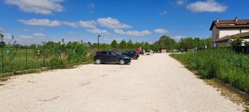 two cars parked on the side of a dirt road at Cascina Boroardo D4 in Cremona