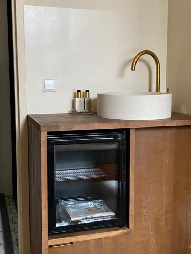 a kitchen with a fireplace and a sink at Gorgeous room near Haarlem Station, city center in Haarlem