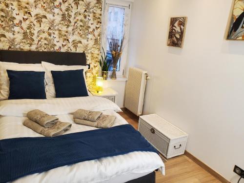 a bedroom with a bed with two pillows on it at Mirka & Franck AIRCON Apartment Chic 4" Stars Parking Free, Garage & Wine with Avantages Pack in Colmar