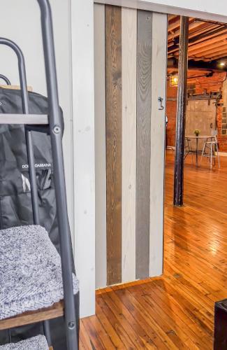 a room with a wooden floor and a ladder at Stylish Philly Loft in Philadelphia