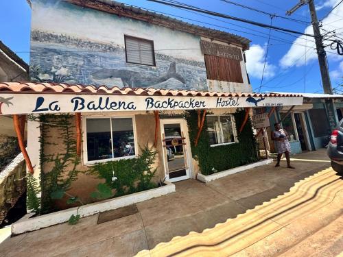 a building with a sign that reads la ballena rochelle restaurant at Hostel La Ballena Backpacker in Las Galeras