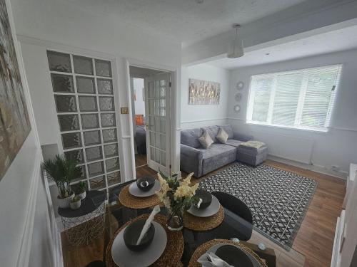 a living room with a couch and a table at St Albans City Stays - Near Luton Airport - St Albans Abbey & City Train station - Close to London- Harry Potter World - The Odyssey Cinema - Abbey Cathedral- Contractors I Business I Leisure- sleeps upto 6 people in St. Albans