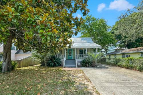 a house with a green door and a driveway at Bear Point Cottage in Orange Beach