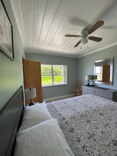 una camera con letto e ventilatore a soffitto di Ocean Front Paradise Resort a Melbourne