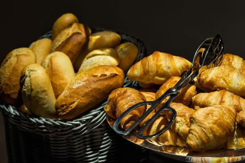a basket full of bread and pair of scissors at Midnight Hotel Paris in Paris