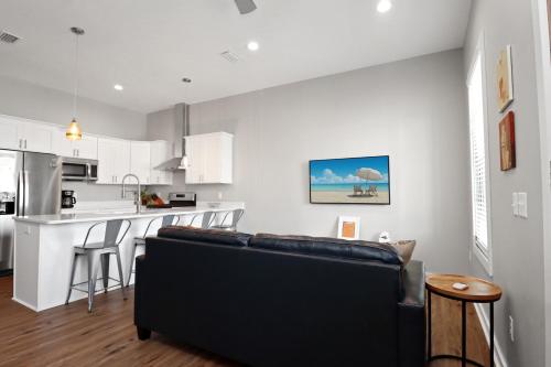 a living room with a couch and a kitchen at Gin Fizz by Pristine Properties Vacation Rentals in Port Saint Joe